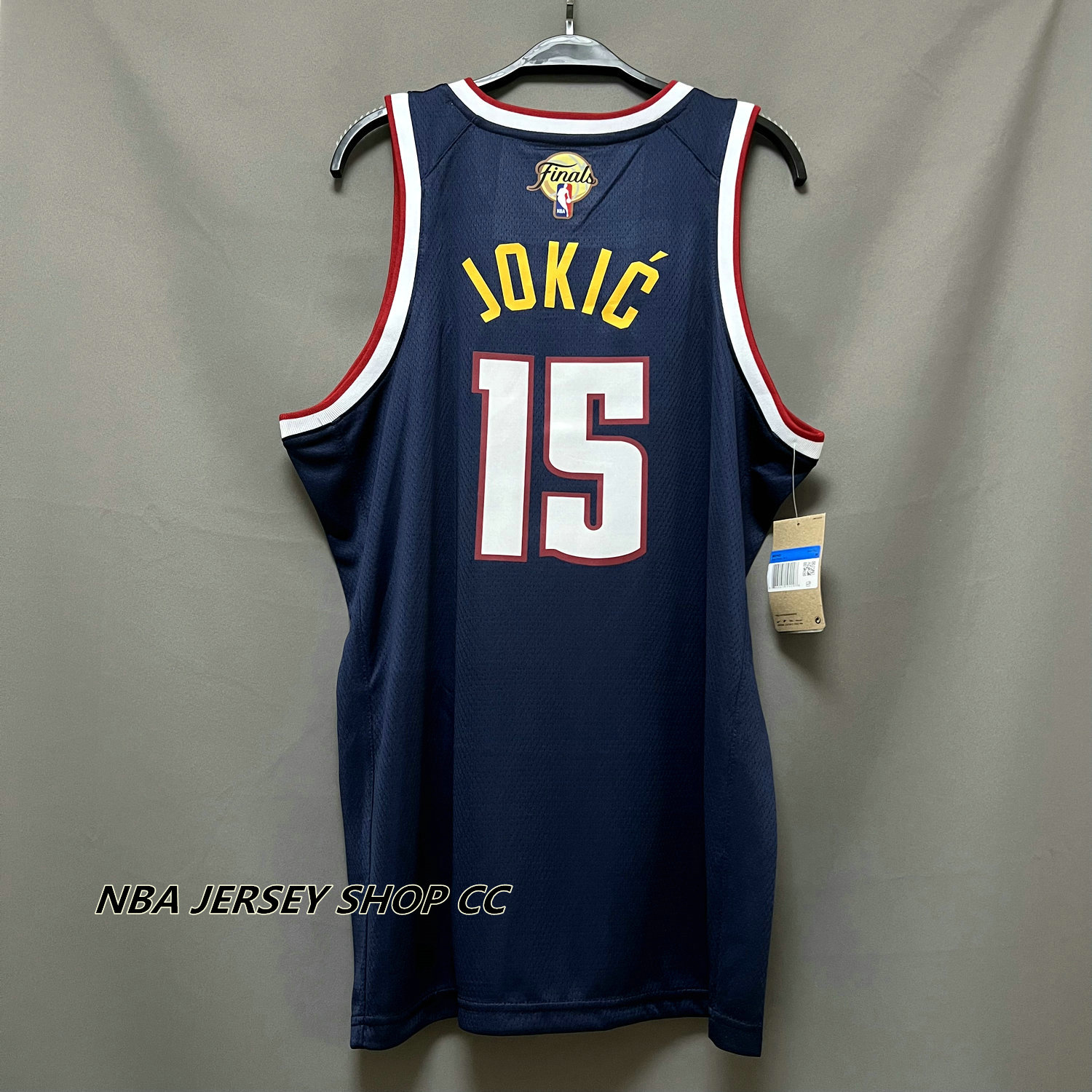 Nikola Jokic Denver Nuggets Unsigned Passing in Navy Jersey Photograph