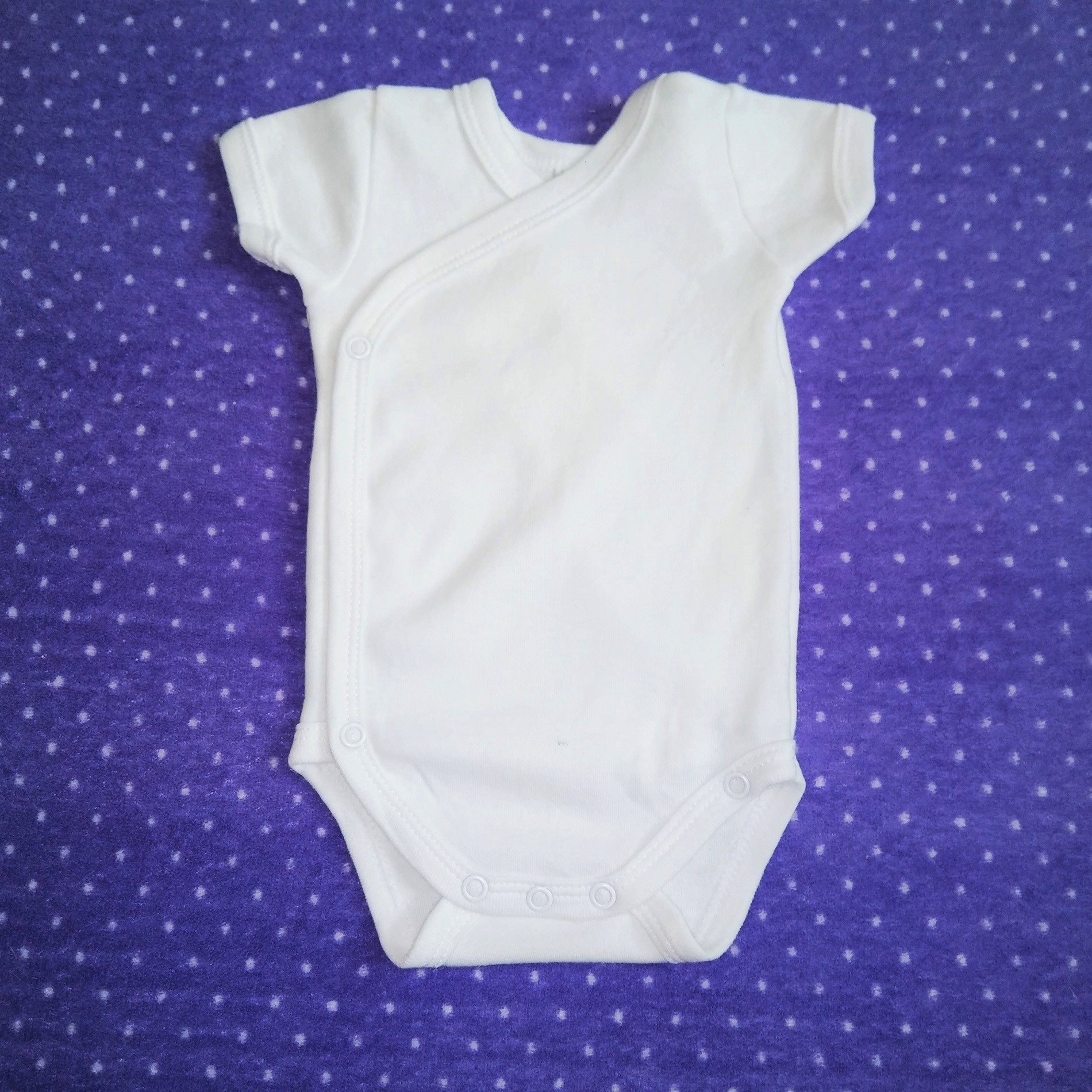 white newborn bodysuit